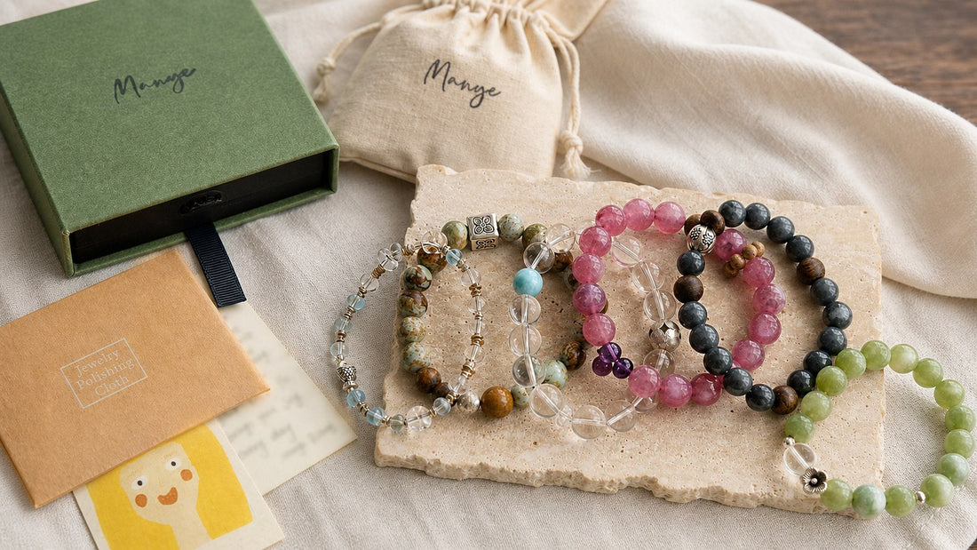 Handmade crystal bracelets arranged with Manye Rituals gift packaging and a handwritten card