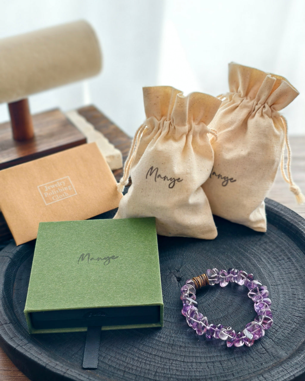 Handmade purple amethyst crystal bracelet with Manye Rituals jewelry packaging