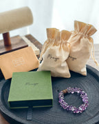 Handmade purple amethyst crystal bracelet with Manye Rituals jewelry packaging