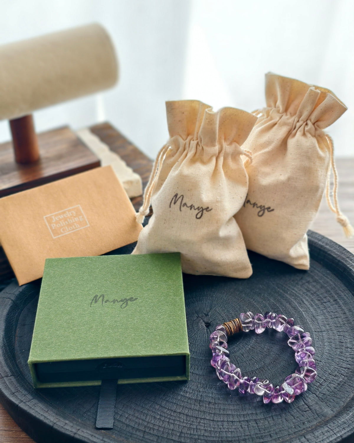 Handmade purple amethyst crystal bracelet with Manye Rituals jewelry packaging