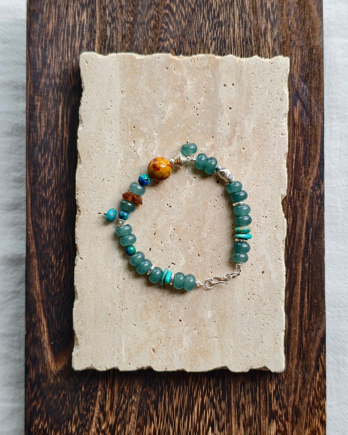 Teal natural stone bracelet displayed on handmade paper background