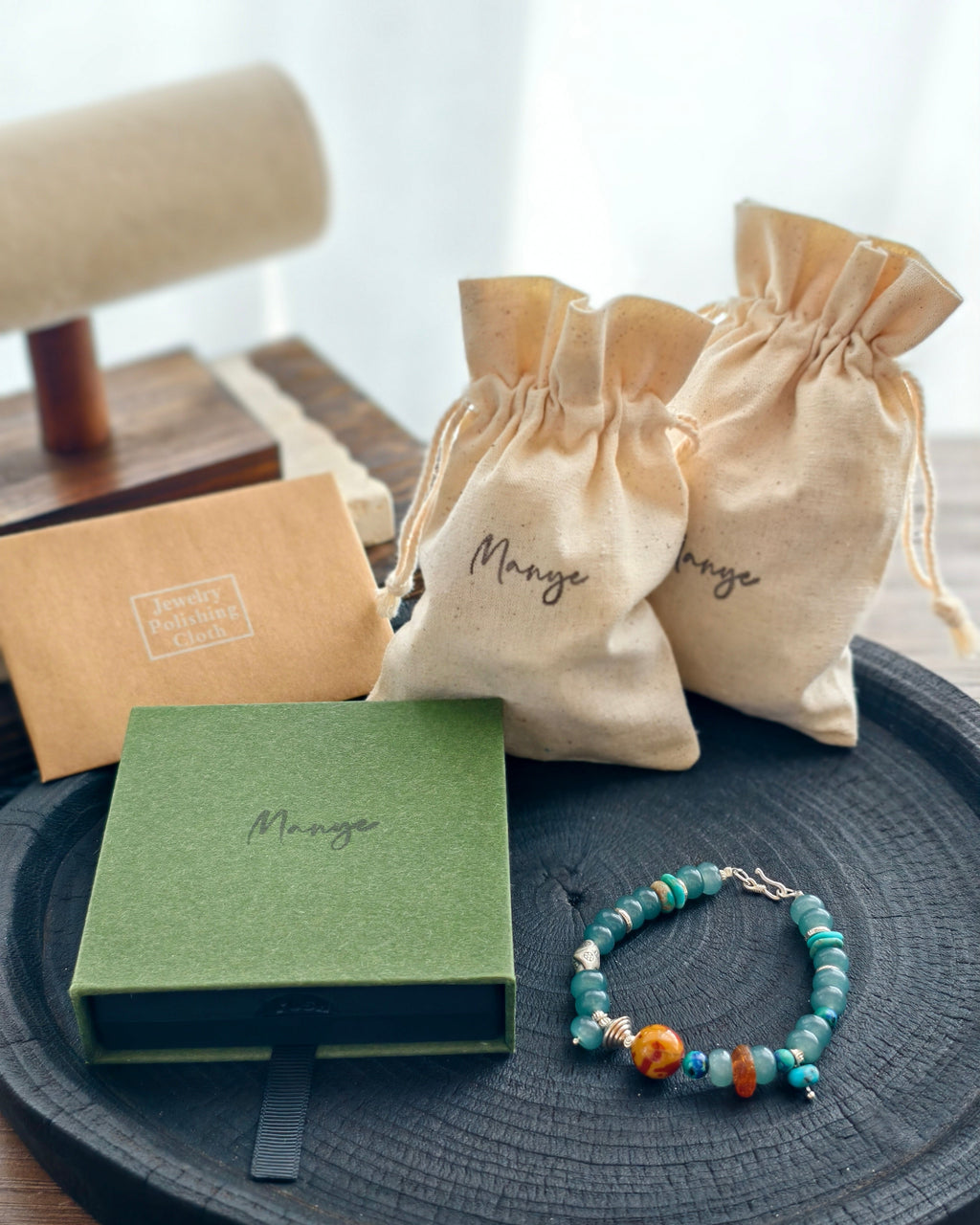Handmade teal stone bracelet with Manye Rituals jewelry packaging