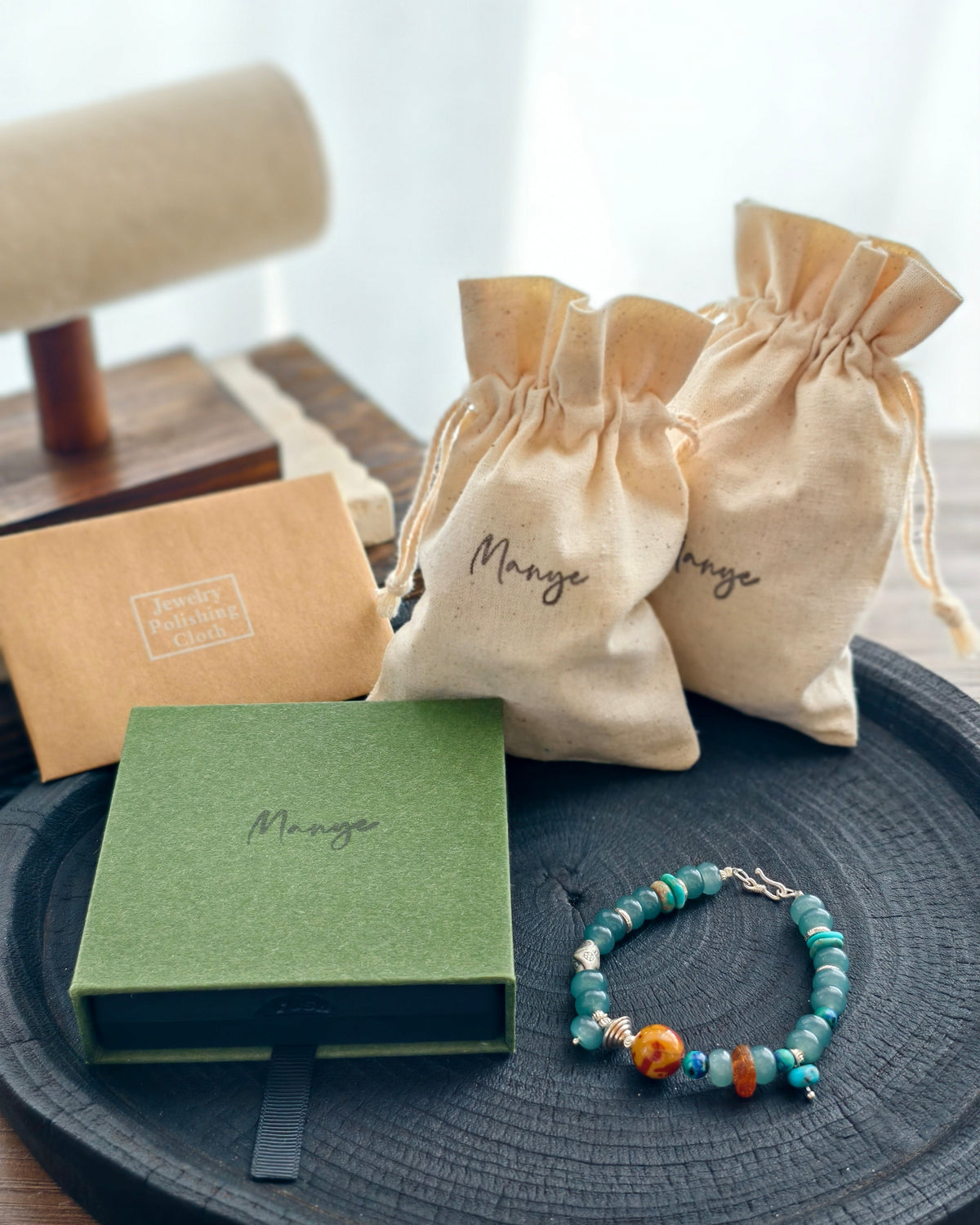 Handmade teal stone bracelet with Manye Rituals jewelry packaging