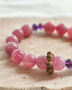 Close-up of pink natural stone beads with purple and gold accent beads
