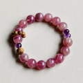 Handmade rose quartz crystal bracelet on a neutral background