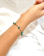 Minimal handmade green stone bracelet worn on the wrist in soft natural light