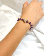 Purple natural stone bracelet with crystal accents worn on the wrist