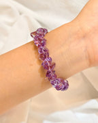 Handmade purple amethyst bracelet worn on the wrist in natural light