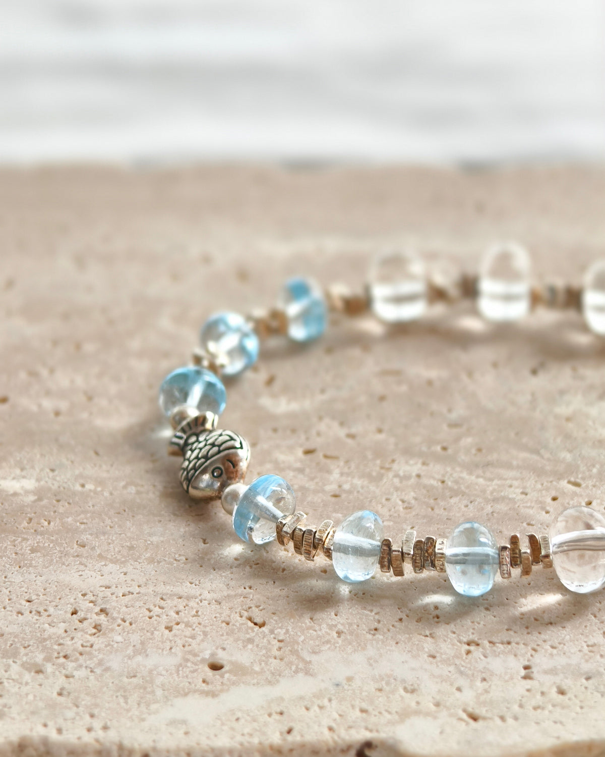 Close-up of blue crystal beads with silver jewelry details