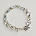 Handmade blue topaz and clear quartz bracelet with silver fish detail
