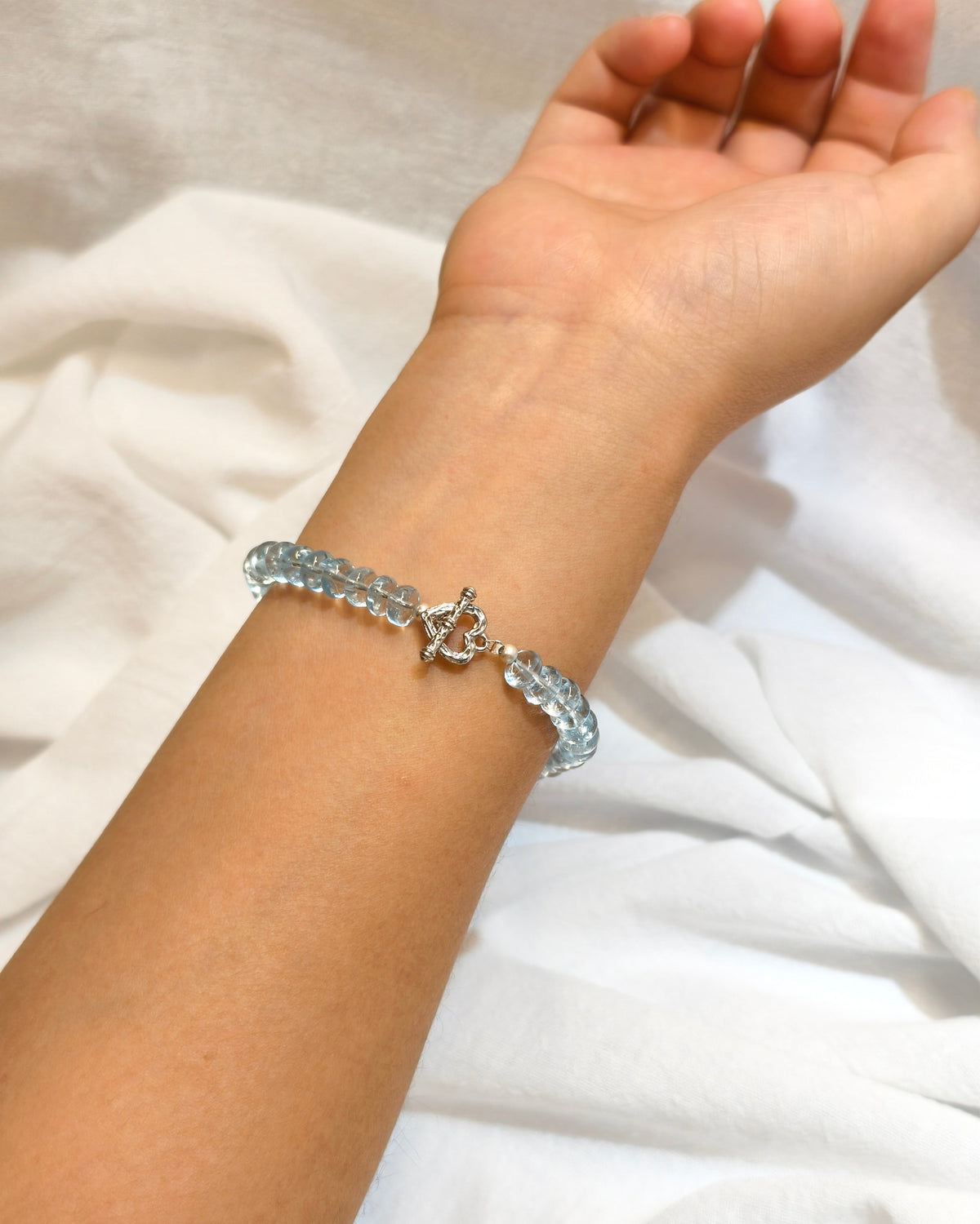 Blue crystal inspired bracelet with ocean colors worn on wrist