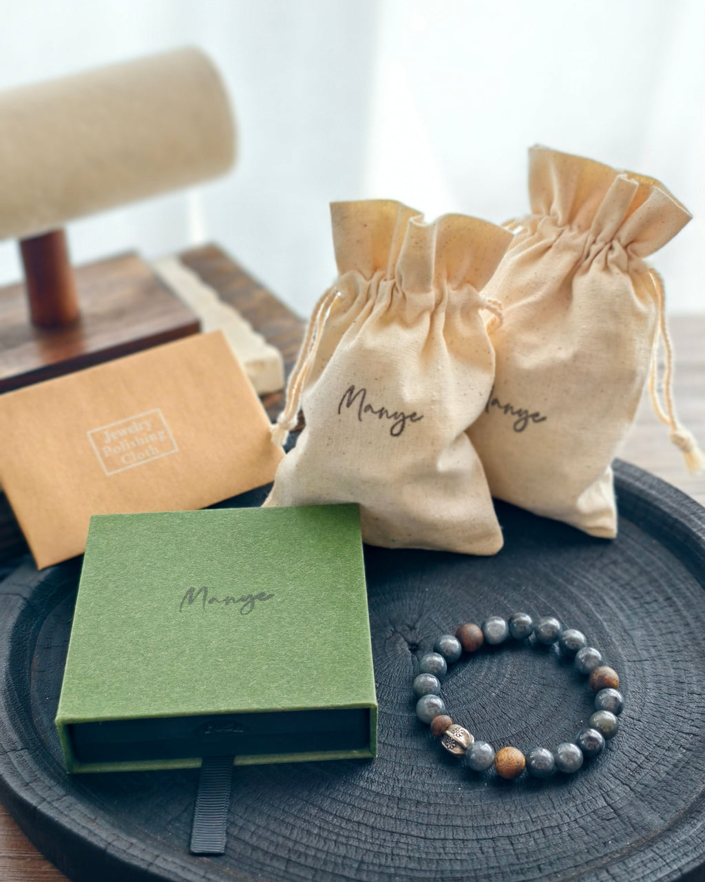 Handmade dark natural stone bracelet with Manye Rituals jewelry packaging
