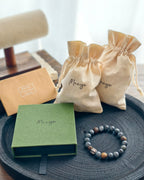 Handmade dark natural stone bracelet with Manye Rituals jewelry packaging