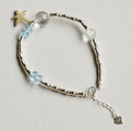 Handmade blue topaz and clear quartz bracelet with starfish charm