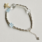 Handmade blue topaz and clear quartz bracelet with starfish charm