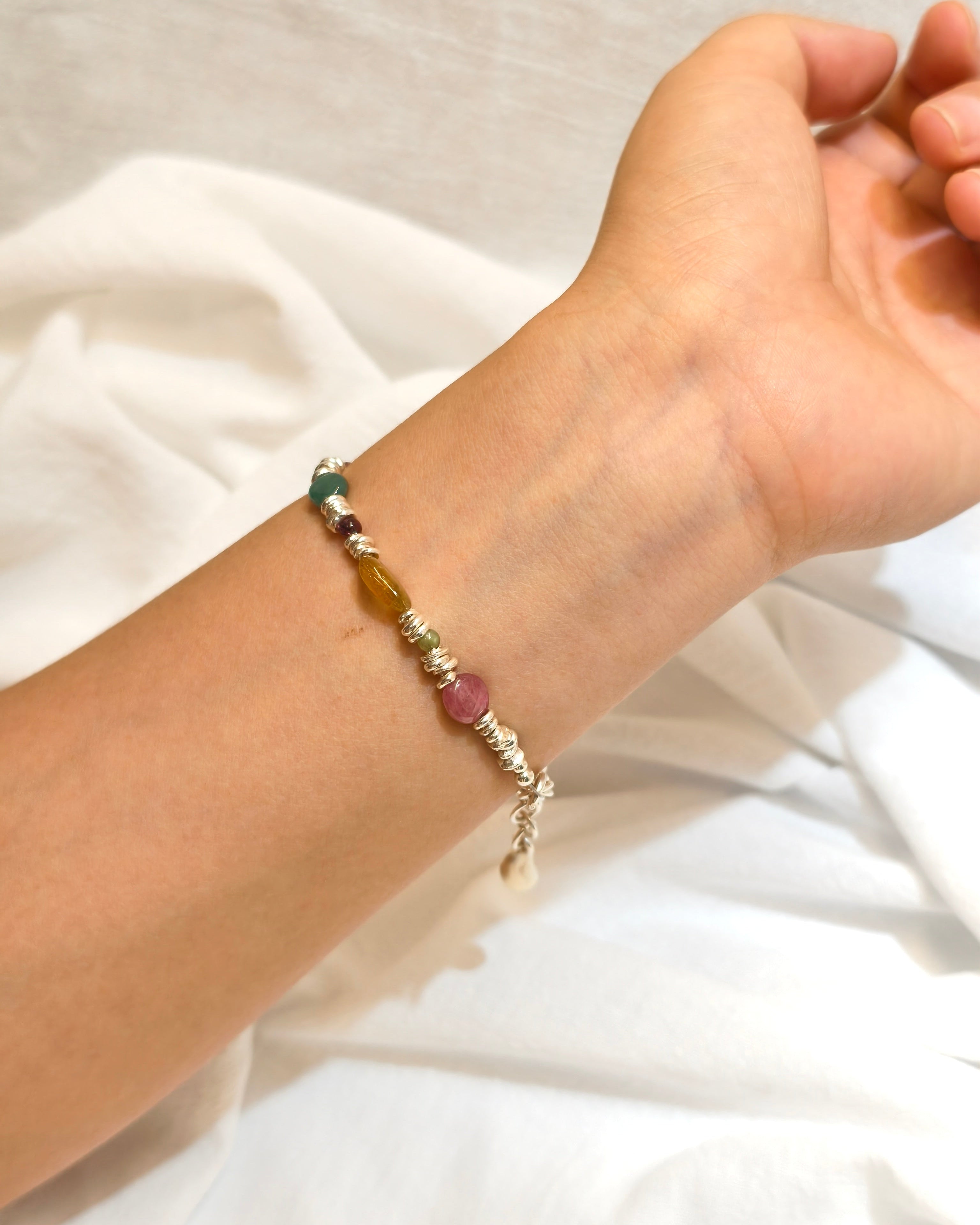 Nature inspired gemstone bracelet with colorful stones worn as handmade jewelry