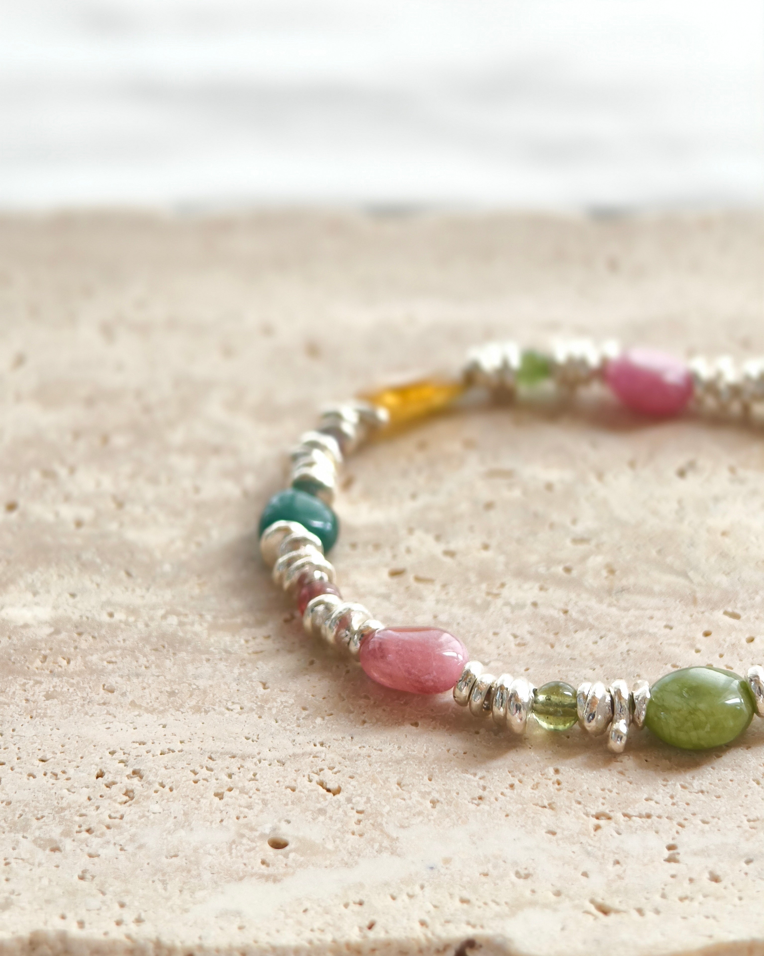 Close-up of colorful natural stone beads on handmade bracelet